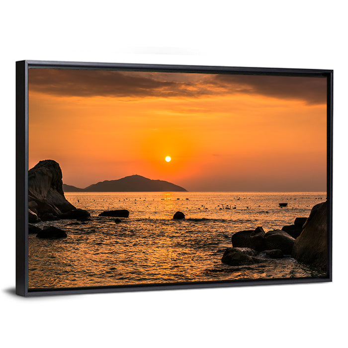 Orange Sunrise Over Rocky Coast Wall Art as a framed canvas
