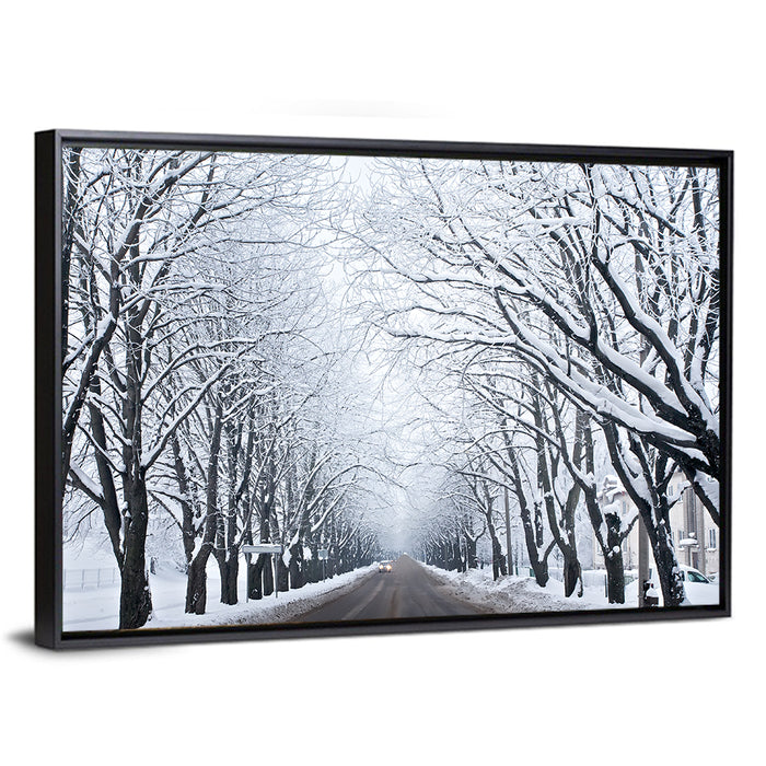Snowy Road with Distant Headlights Wall Art as a framed canvas