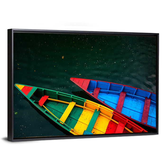 Two Colorful Boats Over Rippling Water Wall Art as a framed canvas