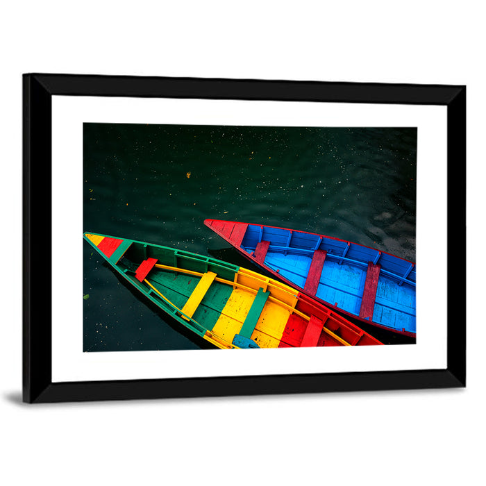 Two Colorful Boats Over Rippling Water Wall Art as a framed print