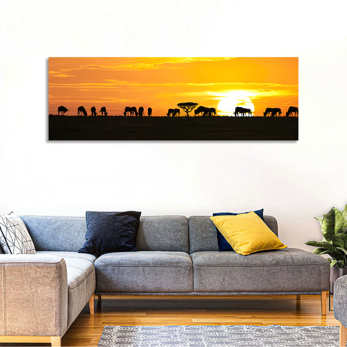 Wildebeest Silhouettes at Sunset Wall Art in a room, panoramic