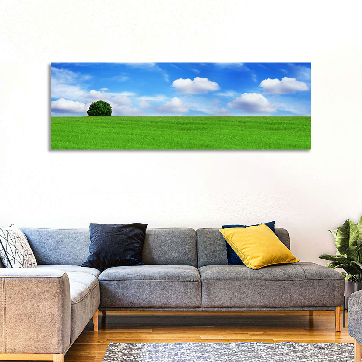 Solitary Tree Over Green Meadow Wall Art in a room, panoramic