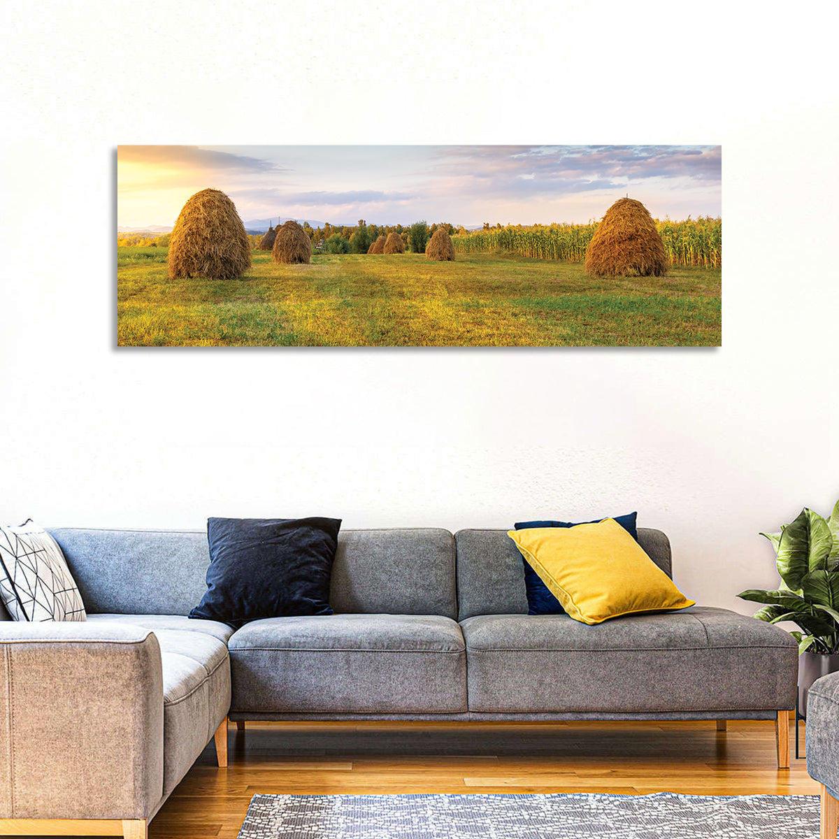 Haystacks at Sunset Fieldscape Wall Art in a room, panoramic