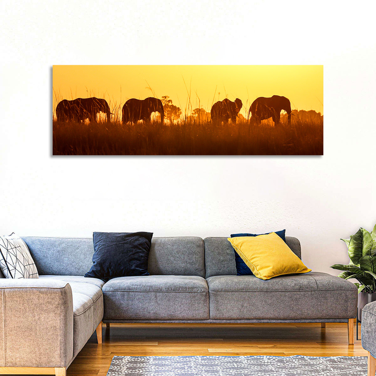 Golden Sunset Elephant Herd Wall Art in a room, panoramic