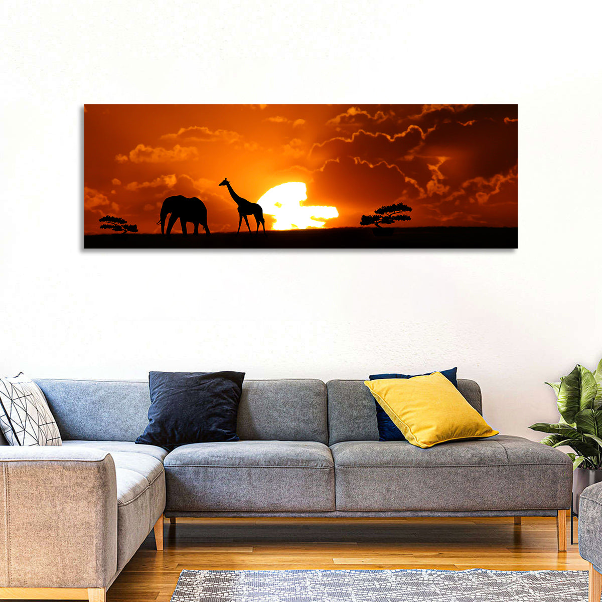 Safari Sunset Silhouettes Wall Art in a room, panoramic
