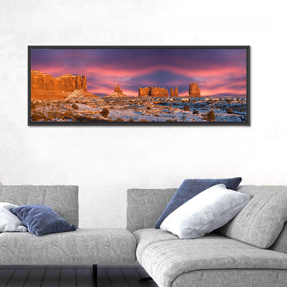 Snow-dusted Monument Valley Sunset Wall Art in a room, panoramic