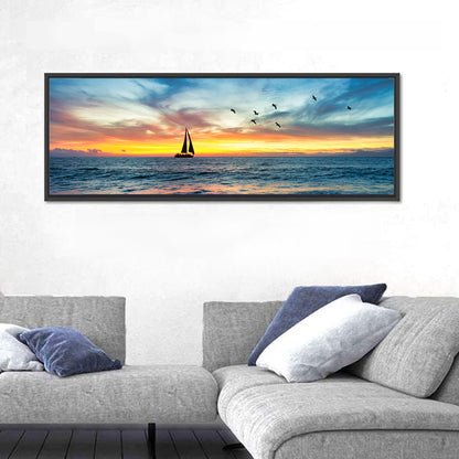 Sunset Sailboat Over Pebble Shore Wall Art