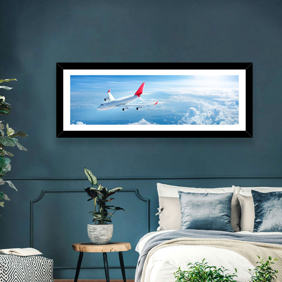 Airplane Over Blue Cloudscape Wall Art in a room, panoramic