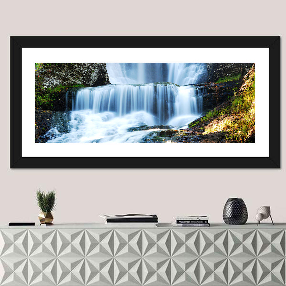 White Waterfall Over Mossy Rocks Wall Art in a room, panoramic