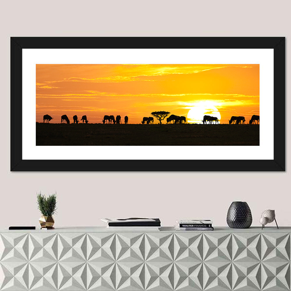 Wildebeest Silhouettes at Sunset Wall Art in a room, panoramic