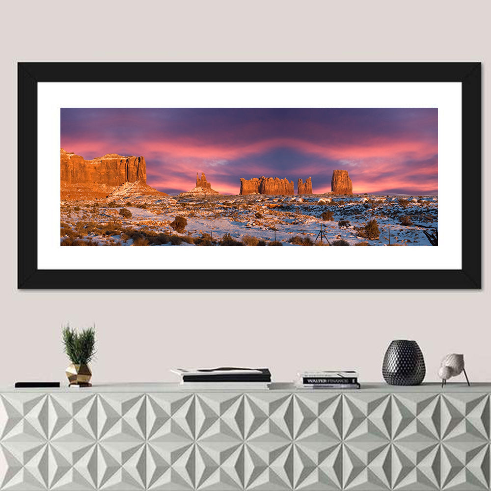 Snow-dusted Monument Valley Sunset Wall Art in a room, panoramic