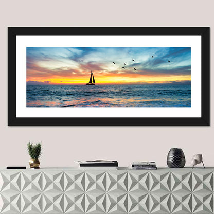Sunset Sailboat Over Pebble Shore Wall Art