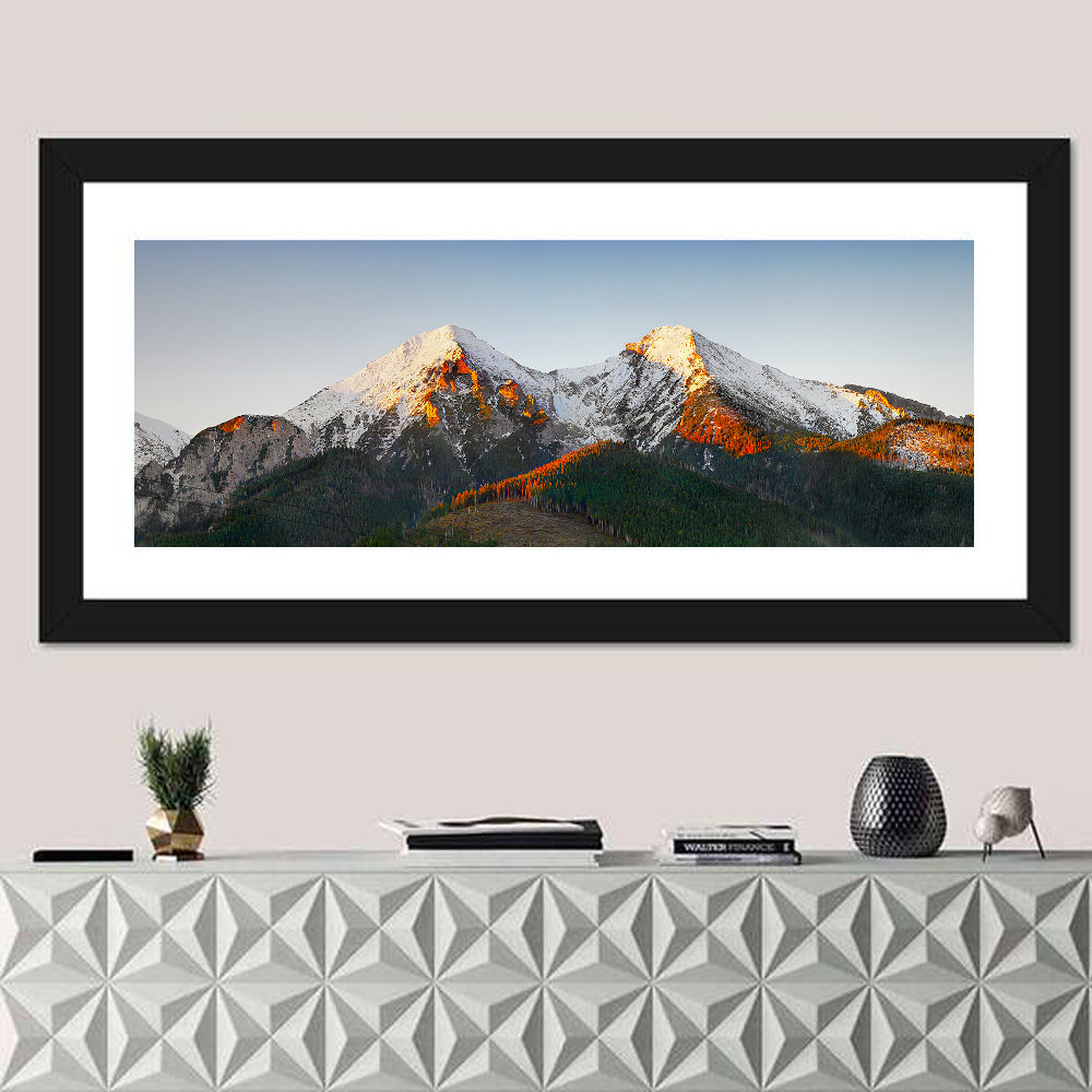 Sunlit Snow Capped Peaks Wall Art in a room, panoramic