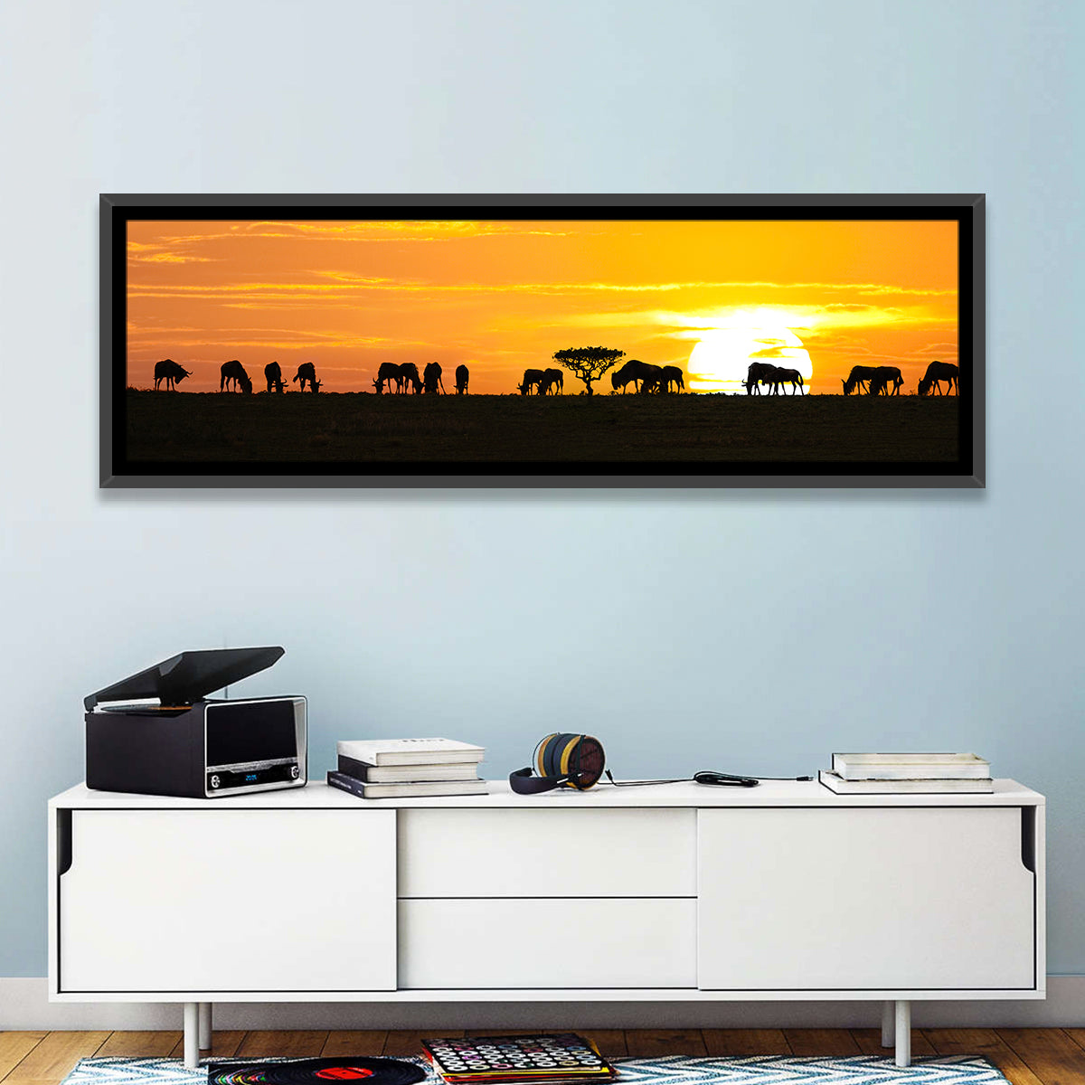 Wildebeest Silhouettes at Sunset Wall Art in a room, panoramic