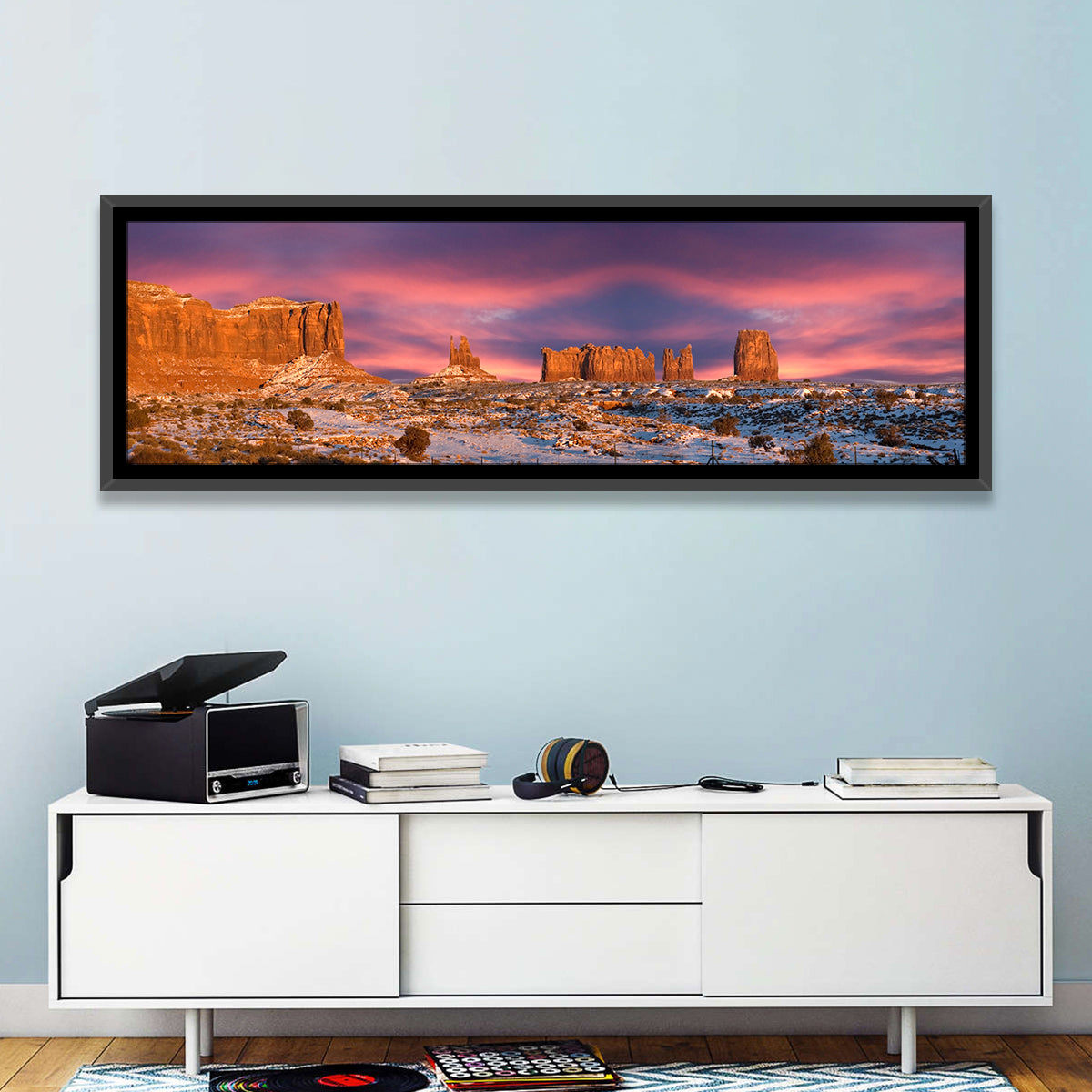 Snow-dusted Monument Valley Sunset Wall Art in a room, panoramic