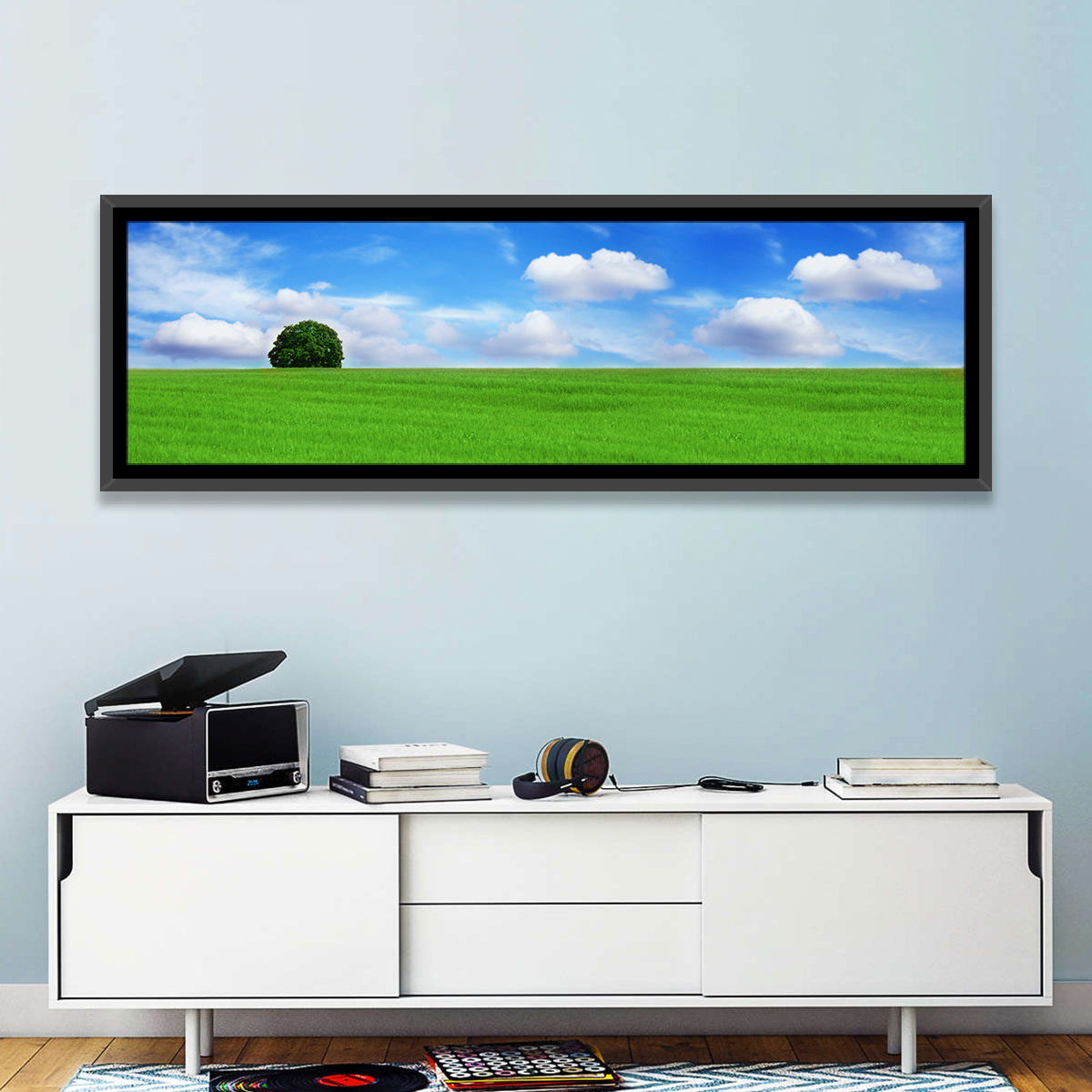 Solitary Tree Over Green Meadow Wall Art in a room, panoramic