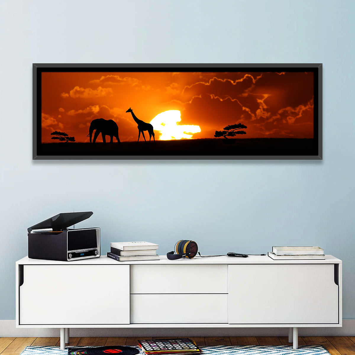 Safari Sunset Silhouettes Wall Art in a room, panoramic