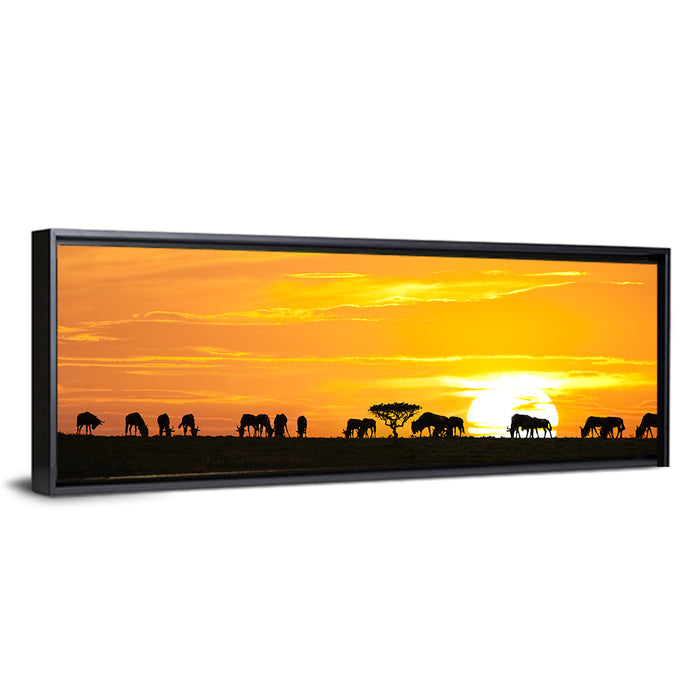 Wildebeest Silhouettes at Sunset Wall Art as a framed canvas