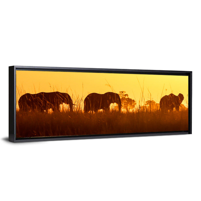 Golden Sunset Elephant Herd Wall Art as a framed canvas