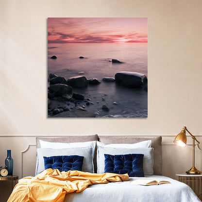 Pink Dusk Lakeshore with Silhouetted Rocks Wall Art