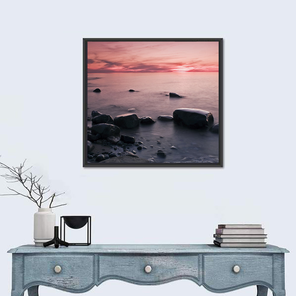 Pink Dusk Lakeshore with Silhouetted Rocks Wall Art