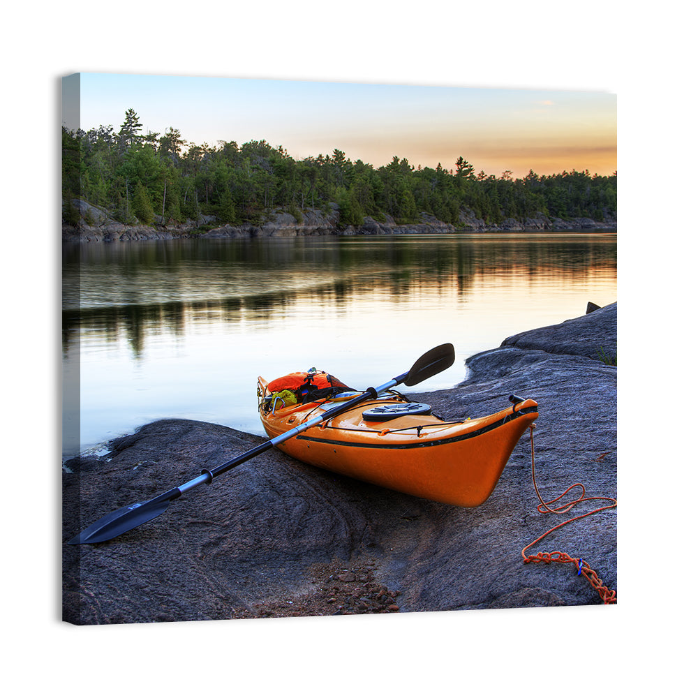 Orange Kayak on Rocky Shore Wall Art