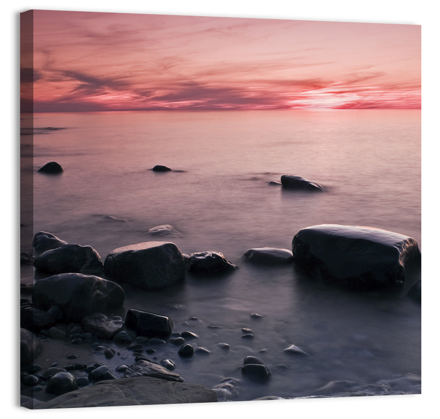 Pink Dusk Lakeshore with Silhouetted Rocks Wall Art