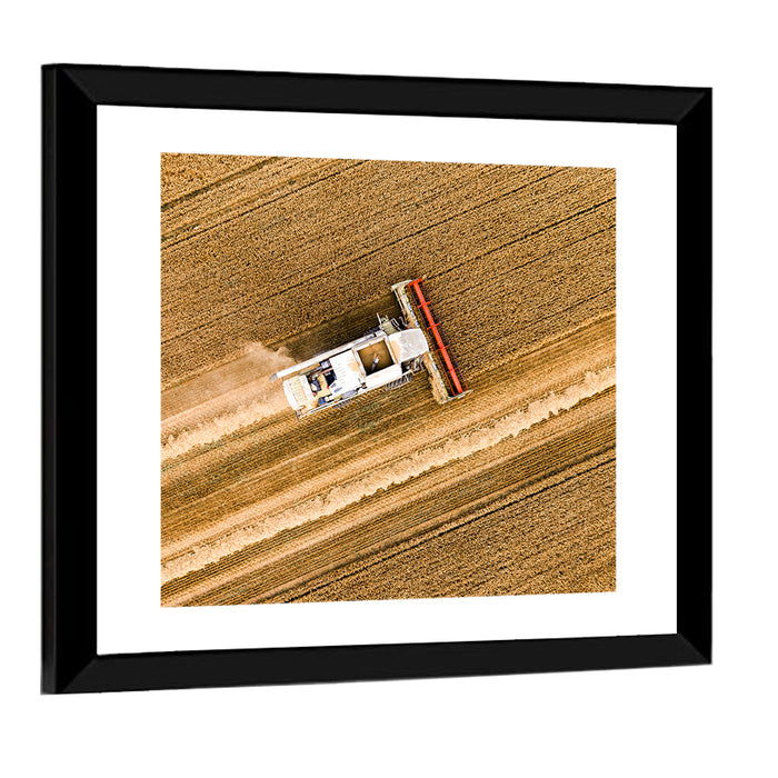 Aerial Combine Over Wheat Field Wall Art as a framed print