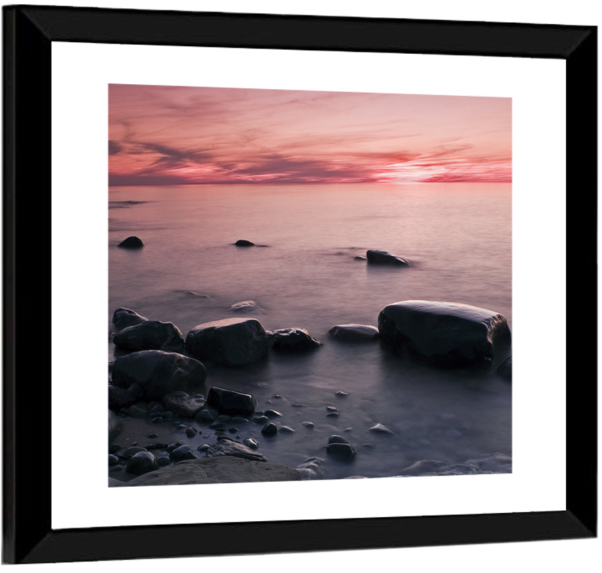 Pink Dusk Lakeshore with Silhouetted Rocks Wall Art