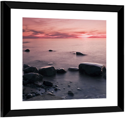 Pink Dusk Lakeshore with Silhouetted Rocks Wall Art